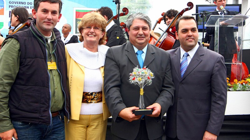 A gerente do projeto Prefeitura Parceira, Helena Hermany, acompanhada do secret&aacute;rio de Estado do Meio Ambiente, Giancarlo Tusi Pinto(D), durante a entrega do trof&eacute;u Concurso Cidade Mais Florida ao prefeito de Gramado, Nestor Tissot.