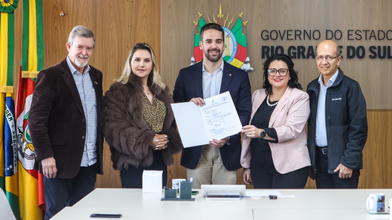 Eduardo Leite ao centro segurando a licença ambiental acompanhado pelos representantes da empresa, a secretária do Meio Ambiente e Infraestrutura e o presidente da Fepam.