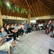 Foto mostra plateia assistindo exposição de palestrante no workshop da campanha Viva o Verão Gaúcho