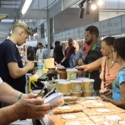 Foto do Pavilh&atilde;o da Agricultura Familiar mostra feirantes e p&uacute;blico na feira. 